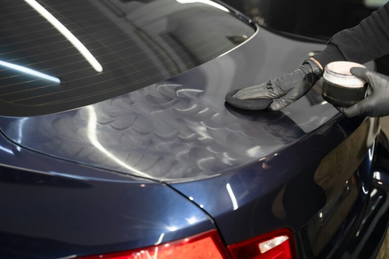 detailing-master-applies-polishing-wax-to-the-car-body-auto-detailing-concept